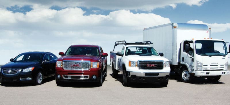 image of a sedan, pickup truck, work pickup truck, and box truck parked in a row