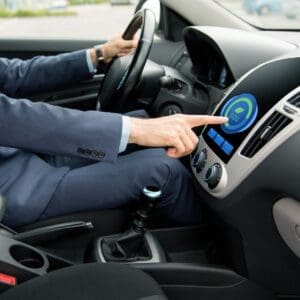 driver pressing eco mode in car