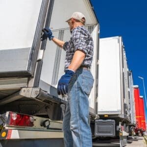 A man opening a semi-truck