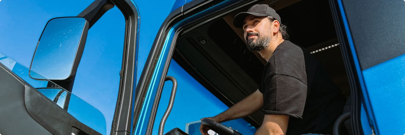 Man sitting in commercial vehicle with the door open