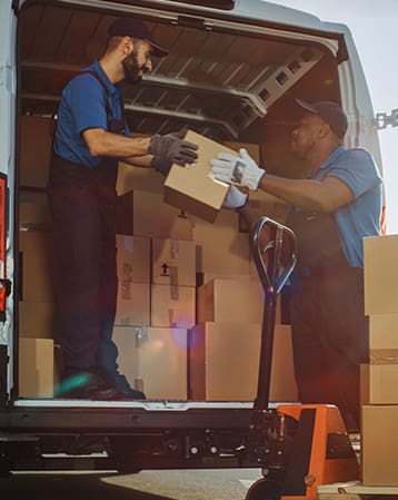 Two men loading packages onto a cargo van