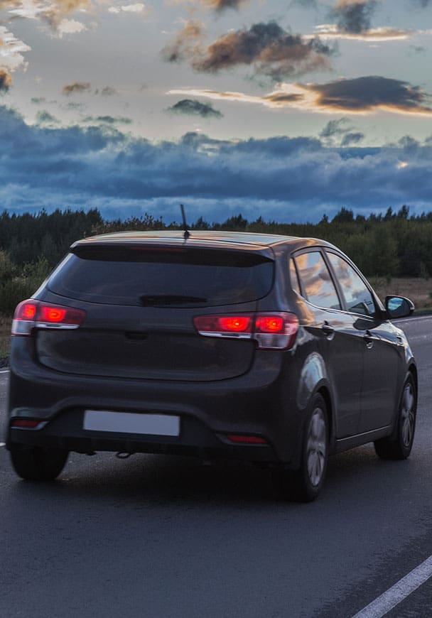 A hatchback for Pharmaceutical delivery traveling down an open road