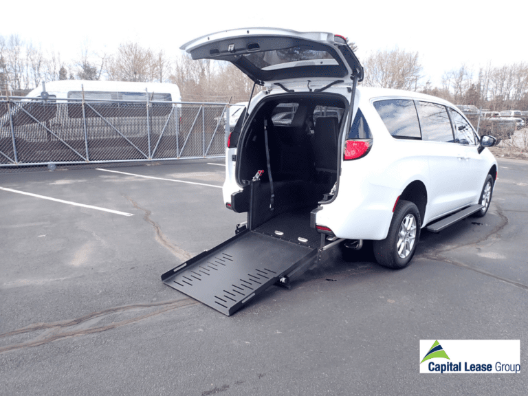 Wheelchair accessible mini van white with wheelchair ramp in rear of the van. Ramp is deployed