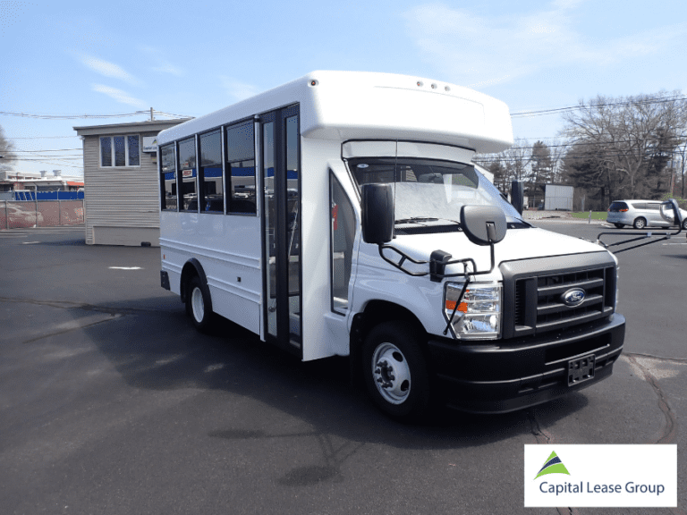 Exterior passenger-side angle of a white school activity bus.